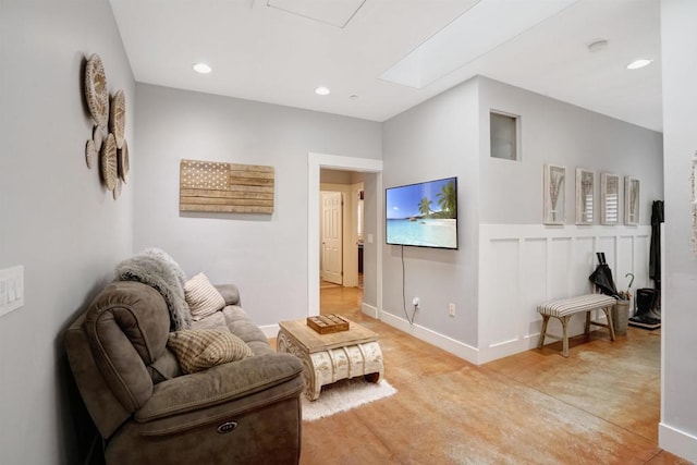 tiled living room featuring a skylight