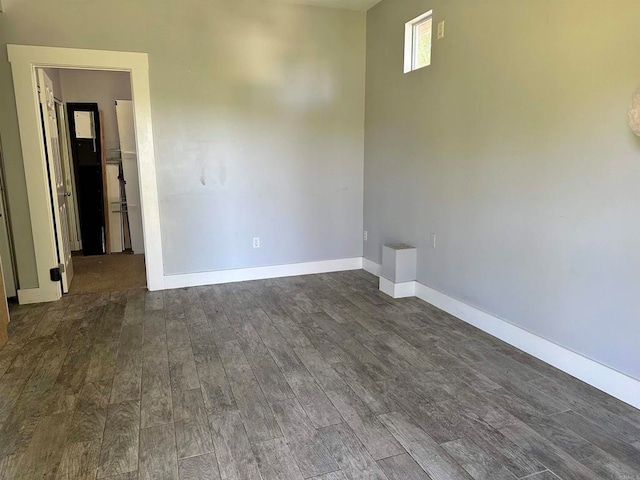 unfurnished room with dark hardwood / wood-style flooring