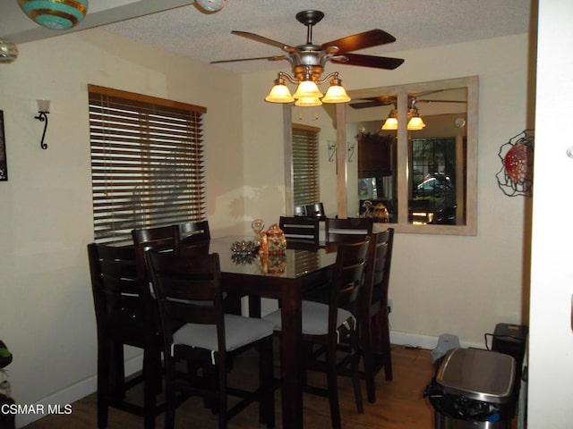 dining space with wood-type flooring, a textured ceiling, and ceiling fan