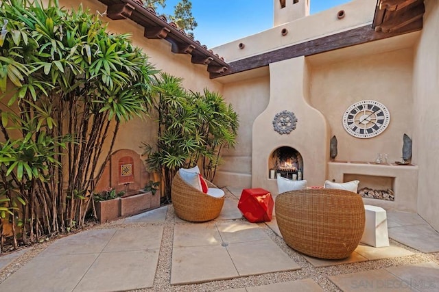 view of patio / terrace featuring exterior fireplace