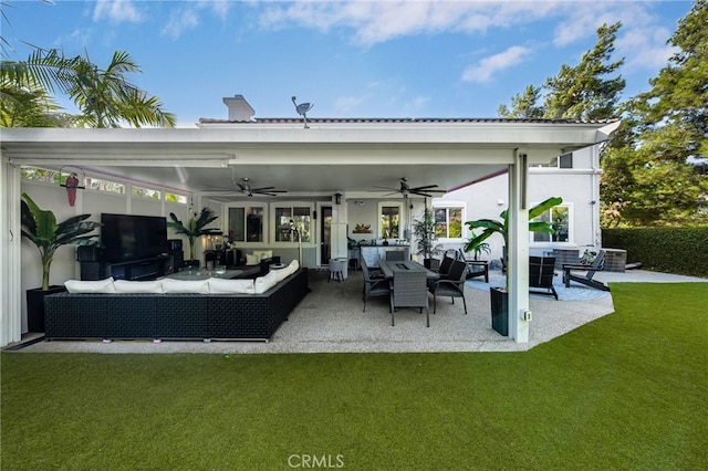 back of house with a yard, an outdoor living space, ceiling fan, and a patio area