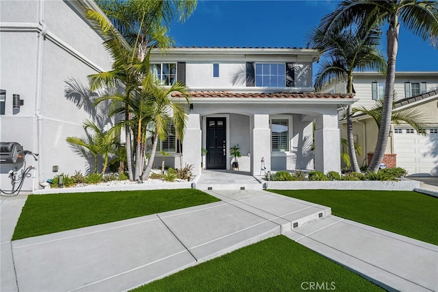 view of front of home with a garage and a front yard