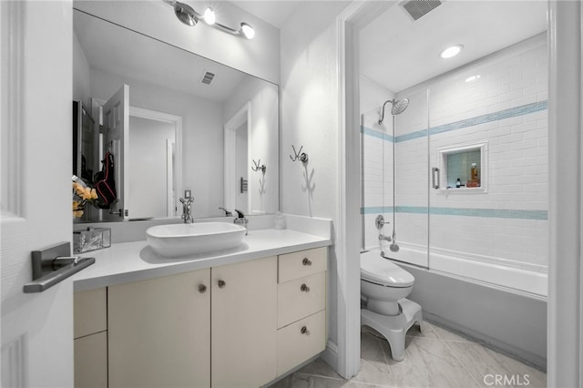 full bathroom with shower / bath combination with glass door, vanity, and toilet