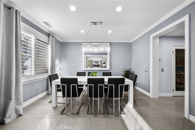 tiled dining room with crown molding and a chandelier