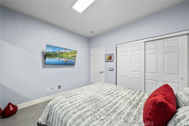 bedroom featuring hardwood / wood-style floors and a closet