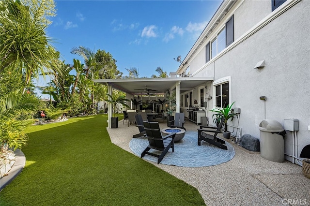 view of yard featuring ceiling fan and a patio area