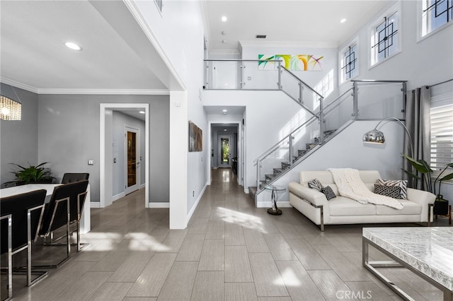 interior space with ornamental molding and hardwood / wood-style floors