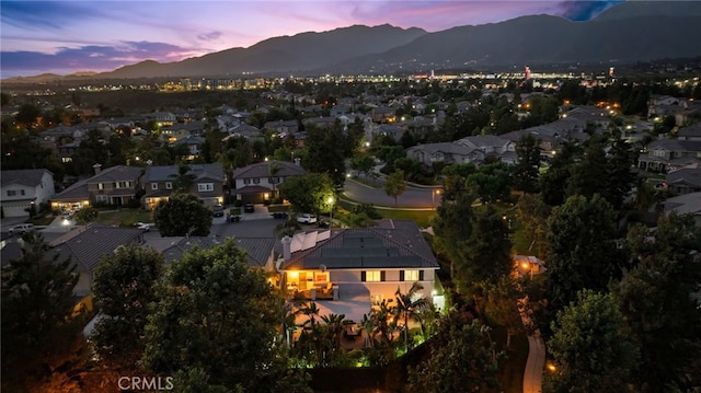 aerial view at dusk featuring a mountain view