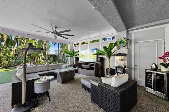 living room with a textured ceiling, ceiling fan, and wine cooler