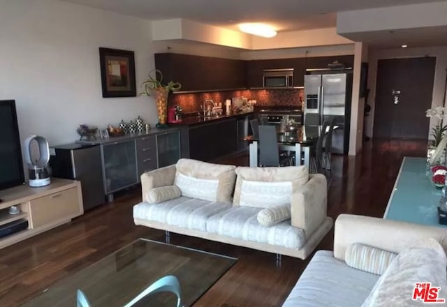 living room with sink and dark hardwood / wood-style flooring