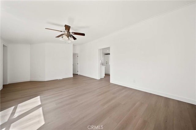 spare room with ceiling fan, crown molding, and light hardwood / wood-style flooring