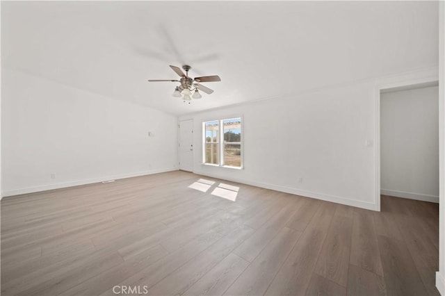 empty room featuring ceiling fan and light hardwood / wood-style flooring