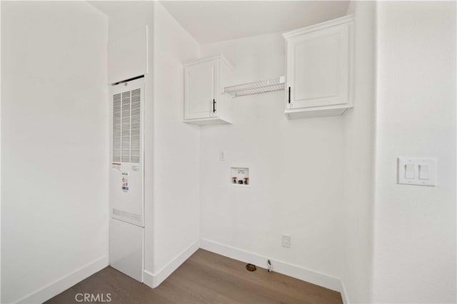 washroom with cabinets, washer hookup, and hardwood / wood-style flooring