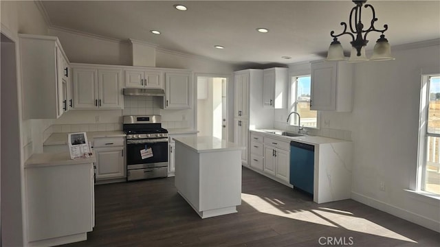 kitchen with white cabinets, a wealth of natural light, a kitchen island, and appliances with stainless steel finishes