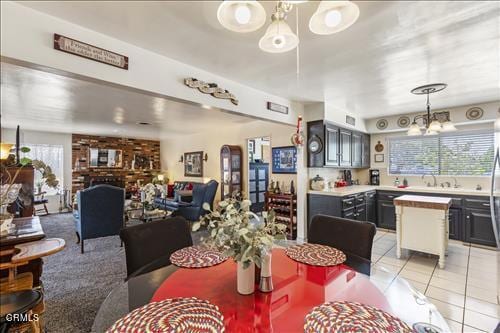 dining room with light tile patterned flooring, a fireplace, and a chandelier