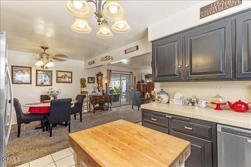 kitchen with light tile patterned flooring, dishwasher, and ceiling fan