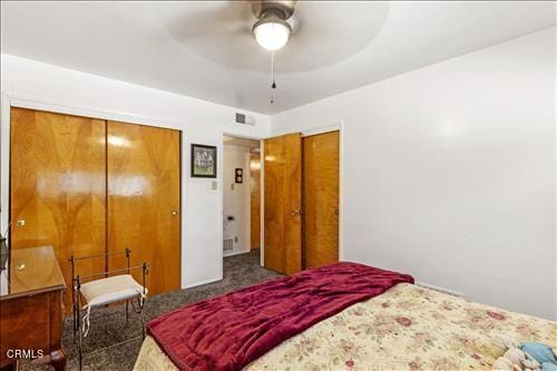 bedroom with ceiling fan and dark colored carpet