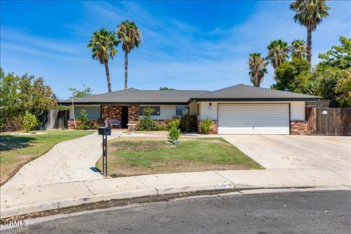 ranch-style house featuring a garage and a front lawn