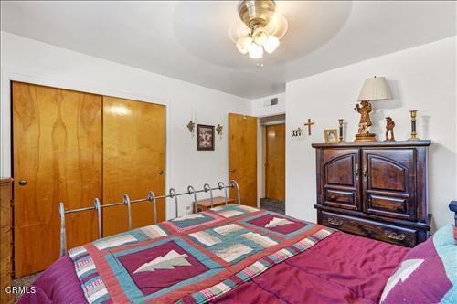 bedroom featuring ceiling fan and a closet