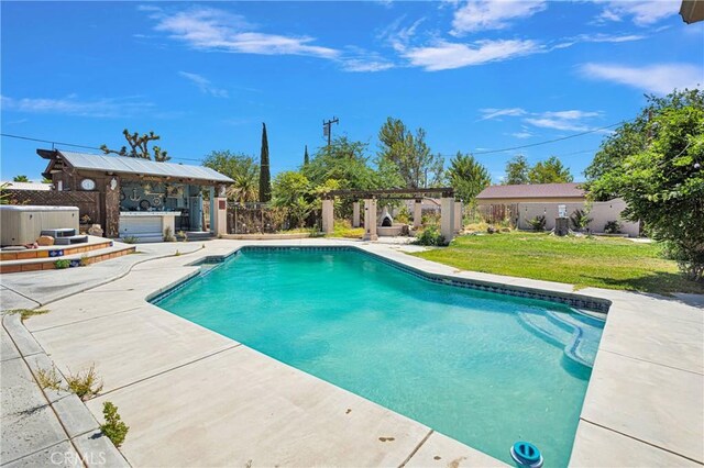 view of swimming pool with a patio area and a yard