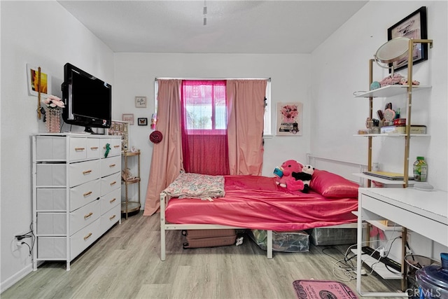 bedroom with light wood-type flooring