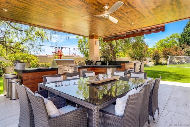 view of patio / terrace featuring ceiling fan, area for grilling, and an outdoor kitchen