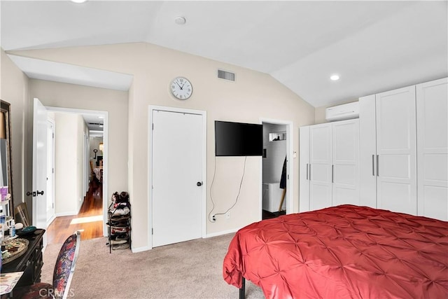 carpeted bedroom with a wall mounted air conditioner, a closet, and vaulted ceiling