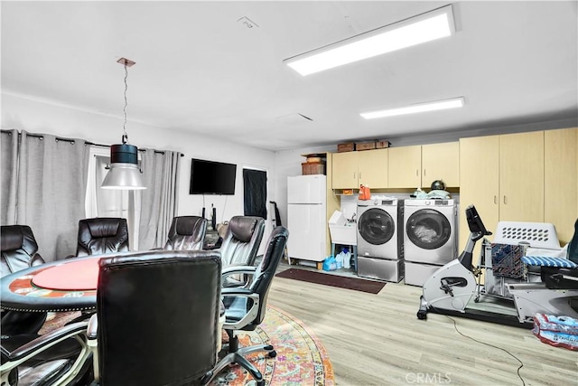 interior space with light wood-type flooring and washer and clothes dryer