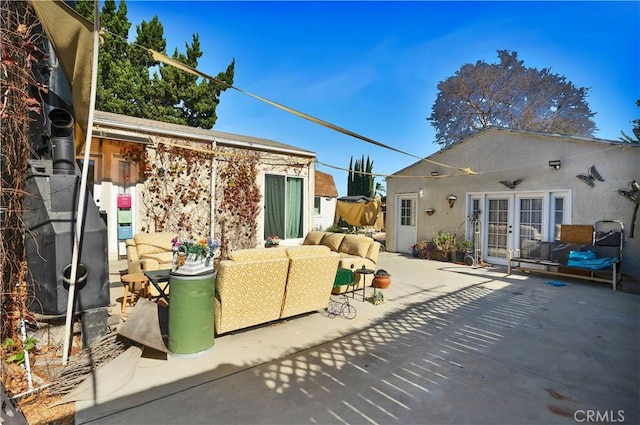 rear view of house featuring french doors, an outdoor hangout area, and a patio area