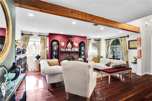 living room with beamed ceiling, a fireplace, and dark wood-type flooring