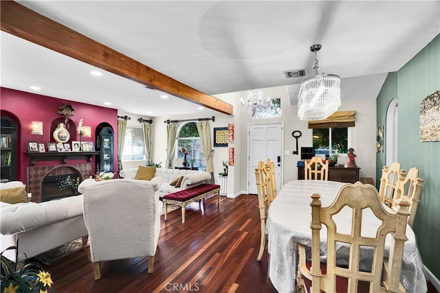 dining area with beamed ceiling, dark wood-type flooring, and a notable chandelier