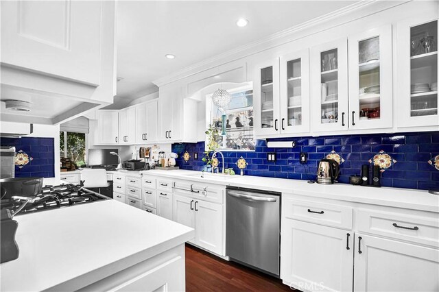 kitchen featuring dishwasher, decorative backsplash, white cabinetry, and sink