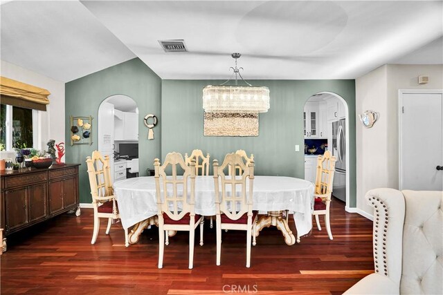 dining room with dark wood-type flooring and a chandelier