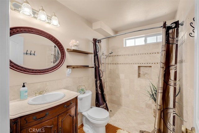 bathroom featuring vanity, toilet, curtained shower, and tile walls