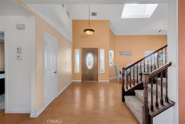 foyer with light hardwood / wood-style floors and a wealth of natural light