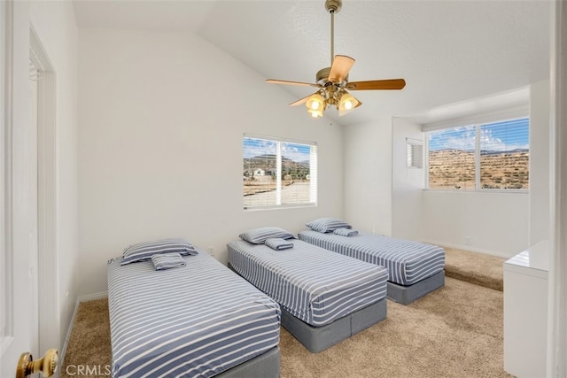 carpeted bedroom with vaulted ceiling and ceiling fan