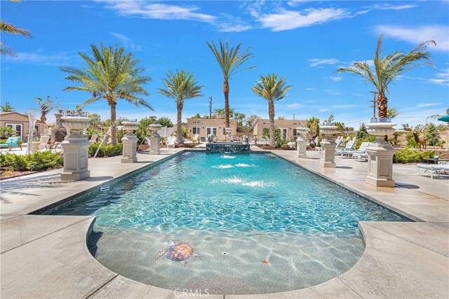 view of pool with pool water feature and a patio area