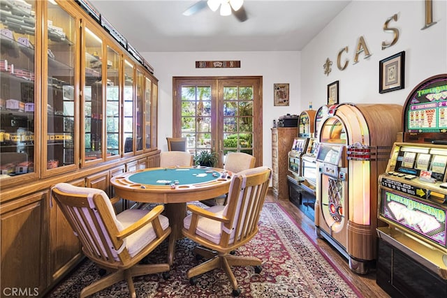 dining space with wood-type flooring, ceiling fan, and french doors