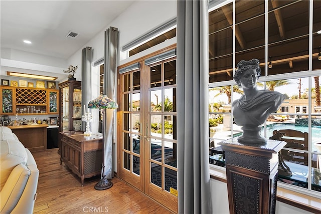 interior space with hardwood / wood-style floors and french doors