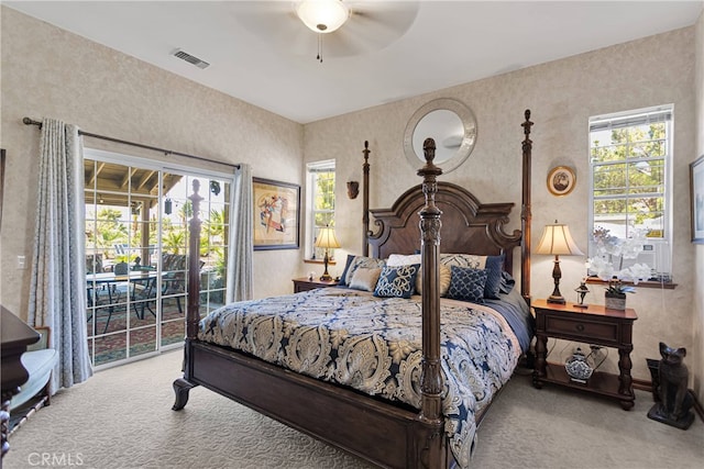 carpeted bedroom with ceiling fan and access to outside