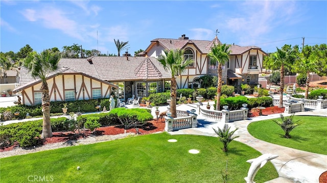 view of front of house featuring a front lawn and a patio