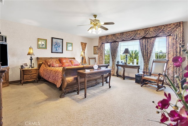 bedroom with multiple windows, carpet floors, and ceiling fan