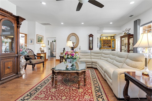 living room with light wood-type flooring and ceiling fan