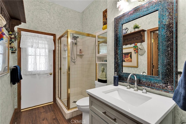 bathroom featuring walk in shower, toilet, vanity, and hardwood / wood-style floors