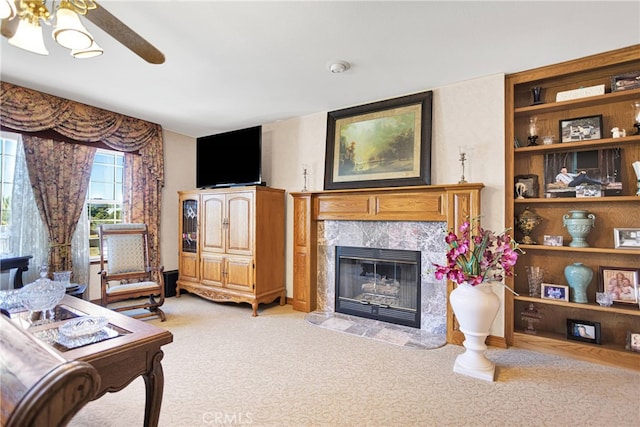 living room featuring a fireplace, ceiling fan, and light colored carpet