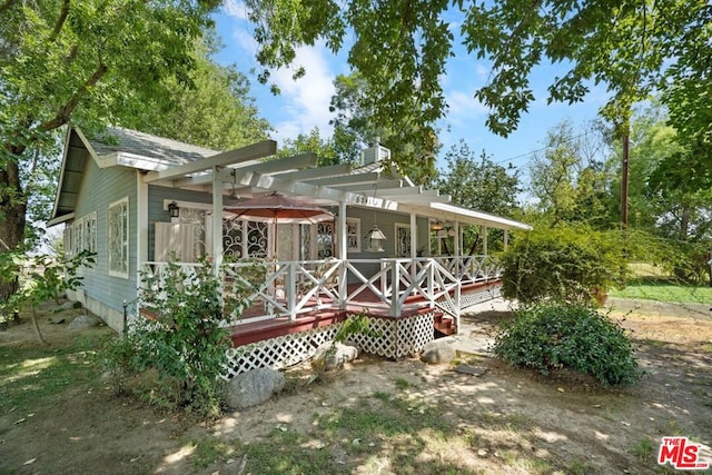 rear view of property featuring a deck