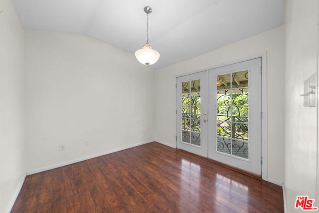 empty room with french doors, dark wood-type flooring, and vaulted ceiling