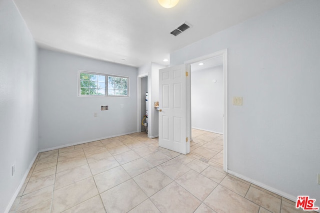 unfurnished room with light tile patterned floors