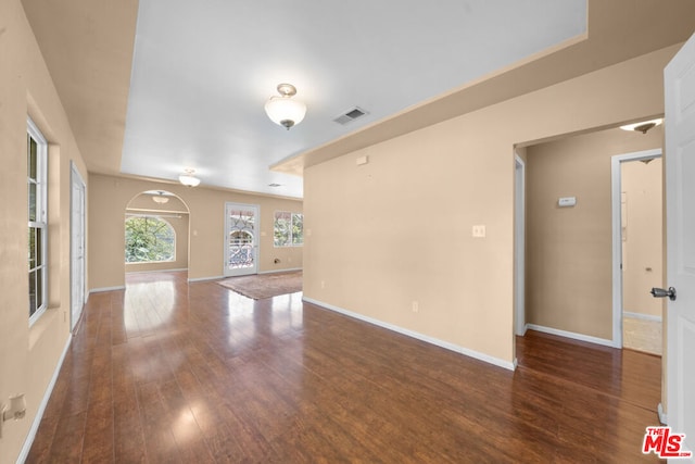 unfurnished living room with dark hardwood / wood-style flooring