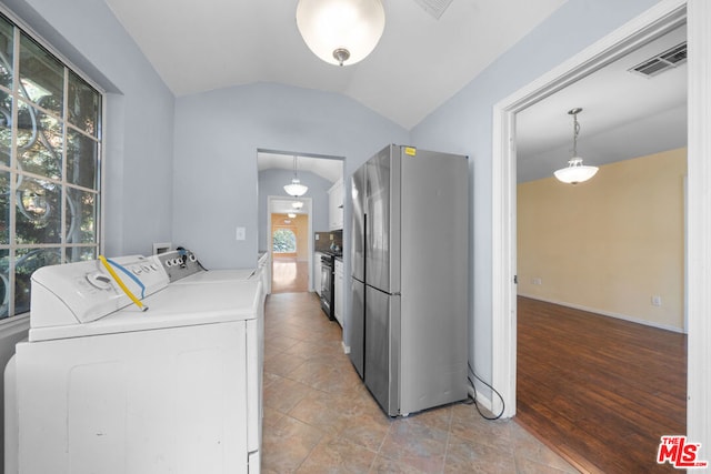 washroom with washer and dryer and light wood-type flooring